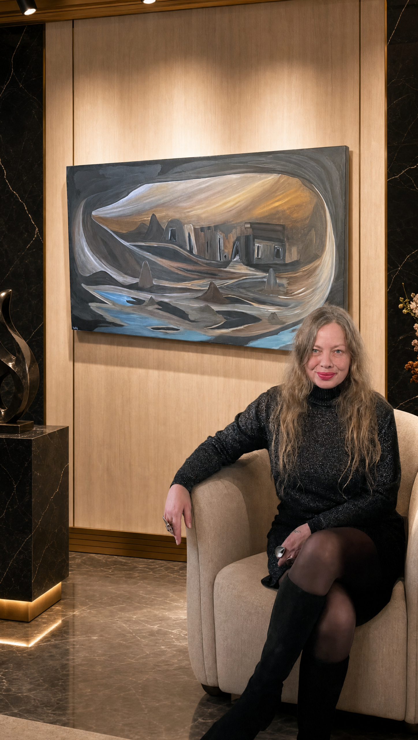 Shani Shtalryd beside one of her original surreal paintings